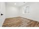 Bright bedroom with hardwood floors and a large window, creating a warm and inviting atmosphere at 1351 S Milwaukee St, Denver, CO 80210