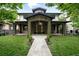 Inviting stone-clad home with a grand entrance, covered porch, and well-manicured lawn at 1351 S Milwaukee St, Denver, CO 80210