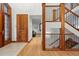 Elegant foyer featuring hardwood floors, a staircase with modern railings, and a glimpse of the living area at 1351 S Milwaukee St, Denver, CO 80210