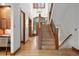 Spacious foyer with hardwood floors, a staircase, and a view of the entry featuring a wood door at 1351 S Milwaukee St, Denver, CO 80210
