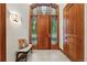 Elegant foyer with a wooden front door, transom windows, and a stylish bench for seating at 1351 S Milwaukee St, Denver, CO 80210