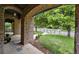 Inviting front porch with stone arches and pillars, offering a glimpse of the green, landscaped yard at 1351 S Milwaukee St, Denver, CO 80210