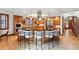Expansive kitchen showcasing a large island with seating, custom wood cabinetry, and stainless-steel appliances at 1351 S Milwaukee St, Denver, CO 80210