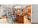 Gourmet kitchen features custom wood cabinetry, stainless steel appliances, and a stylish island with bar seating at 1351 S Milwaukee St, Denver, CO 80210