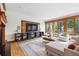 Spacious living room with a fireplace, custom shelving, and a large window at 1351 S Milwaukee St, Denver, CO 80210