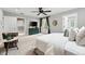 Spacious main bedroom with balcony access, ceiling fan, and ensuite bathroom, blending comfort and style at 1351 S Milwaukee St, Denver, CO 80210