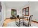 Bright home office with hardwood floors, a wooden-trimmed window, and a comfortable seating area at 1351 S Milwaukee St, Denver, CO 80210