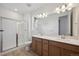 Bathroom featuring double sinks, tile shower, and modern fixtures at 1281 Rock Cliff Ave, Erie, CO 80516