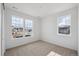 Bright bedroom featuring carpeted floors, two large windows, and neutral walls at 1281 Rock Cliff Ave, Erie, CO 80516