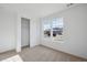 Bright bedroom featuring carpeted floors, two large windows, and closet with sliding door at 1281 Rock Cliff Ave, Erie, CO 80516