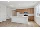 Modern kitchen features a central island, wood cabinets, stainless steel appliances and laminate floors at 1281 Rock Cliff Ave, Erie, CO 80516