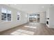 Bright living room featuring laminate floors, large windows, and access to outdoor deck at 1281 Rock Cliff Ave, Erie, CO 80516