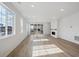 Bright living room featuring laminate floors, large windows, fireplace, and access to outdoor deck at 1281 Rock Cliff Ave, Erie, CO 80516