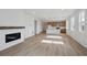Bright, open-concept living area with modern fireplace and kitchen island at 1281 Rock Cliff Ave, Erie, CO 80516