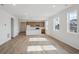 Bright, open-concept living area with modern kitchen island and hardwood floor at 1281 Rock Cliff Ave, Erie, CO 80516