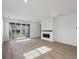 Bright living room featuring laminate floors, fireplace, and access to outdoor deck at 1281 Rock Cliff Ave, Erie, CO 80516
