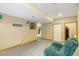 Finished basement area with a cozy recliner and access to other rooms at 1550 Ajax St, Strasburg, CO 80136