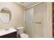 Clean bathroom with a shower featuring sliding glass doors and modern fixtures at 1550 Ajax St, Strasburg, CO 80136