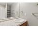 Bright bathroom with a white granite vanity and standing shower in the next room at 1550 Ajax St, Strasburg, CO 80136