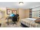 Comfortable bedroom featuring a gaming setup, desk, and natural light at 1550 Ajax St, Strasburg, CO 80136