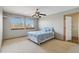 Cozy bedroom featuring a ceiling fan and windows providing natural light at 1550 Ajax St, Strasburg, CO 80136