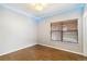 Well lit room with hardwood floors, new lighting accents, and modern window at 1550 Ajax St, Strasburg, CO 80136