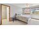 Cozy bedroom with a ceiling fan, plush carpet and bright natural light at 1550 Ajax St, Strasburg, CO 80136