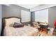Comfortable bedroom includes a desk, chair, and large windows at 1550 Ajax St, Strasburg, CO 80136
