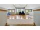 Large bonus room with abundant natural light, plush carpeting, and hardwood floors at 1550 Ajax St, Strasburg, CO 80136