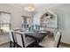 Elegant dining room with stylish chandelier, decorative hutch, and large windows for natural light at 1550 Ajax St, Strasburg, CO 80136