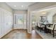 Inviting entryway leading to dining area, featuring tile flooring, coat closet, and sunlit view at 1550 Ajax St, Strasburg, CO 80136