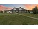 Stunning home with a well manicured yard, blue door and long front porch at 1550 Ajax St, Strasburg, CO 80136