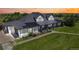 Aerial view of a charming two-story home, featuring solar panels, landscaped yard and an attached garage at 1550 Ajax St, Strasburg, CO 80136