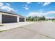 Spacious three car garage and parking area with blue skies at 1550 Ajax St, Strasburg, CO 80136