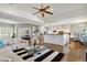Open concept living area with hardwood floors, fireplace, and seamlessly connected kitchen and dining at 1550 Ajax St, Strasburg, CO 80136