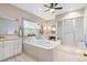 Relaxing main bathroom featuring a soaking tub, shower and dual vanity with great natural light at 1550 Ajax St, Strasburg, CO 80136