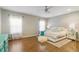 Spacious main bedroom with a modern ceiling fan, hardwood floors and bright natural light at 1550 Ajax St, Strasburg, CO 80136