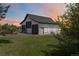 Exterior view of building featuring multiple garage doors and spacious surroundings at 1550 Ajax St, Strasburg, CO 80136