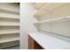 Functional pantry with shelving, countertop, and cabinet space at 1550 Ajax St, Strasburg, CO 80136