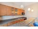 Wet bar boasts wooden cabinets, a sink, and ample counter space at 1550 Ajax St, Strasburg, CO 80136