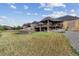 Rolling backyard with lush lawn, stone firepit, rock landscaping and covered patio create a relaxing outdoor oasis at 12939 Wabash Ct, Thornton, CO 80602