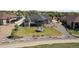 A beautifully landscaped backyard featuring a fire pit, lush green grass, and a covered patio at 12939 Wabash Ct, Thornton, CO 80602