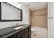 Bathroom with granite countertop, neutral tile, and shower/tub combo at 12939 Wabash Ct, Thornton, CO 80602
