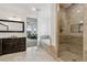 Bathroom featuring dual sinks, a spacious vanity, a glass shower, and a soaking tub at 12939 Wabash Ct, Thornton, CO 80602
