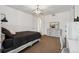 Bedroom with neutral walls, carpet flooring, modern chandelier, and neutral decor at 12939 Wabash Ct, Thornton, CO 80602