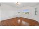 Bright, open bedroom with hardwood floors and windows offering views of the yard at 12939 Wabash Ct, Thornton, CO 80602