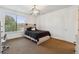 Cozy bedroom with neutral walls, carpet flooring, natural light and modern light fixture at 12939 Wabash Ct, Thornton, CO 80602