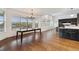 Open-concept dining room features hardwood floors, large windows with scenic views, and flows into the kitchen at 12939 Wabash Ct, Thornton, CO 80602