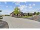 Long driveway leading to a well-maintained home with a three-car garage and attractive landscaping at 12939 Wabash Ct, Thornton, CO 80602
