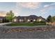 Charming single-story home featuring stone accents, manicured lawn, and lovely landscaping at 12939 Wabash Ct, Thornton, CO 80602